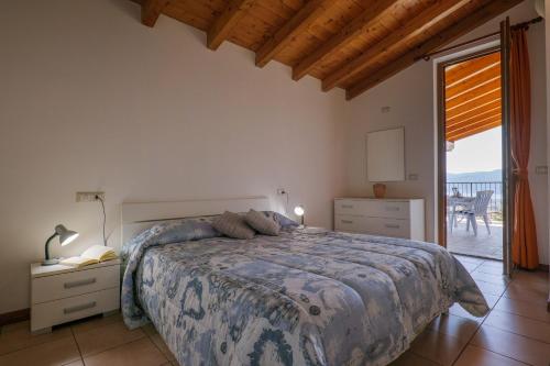 a bedroom with a large bed and a balcony at Panoramic's loft in Verbania