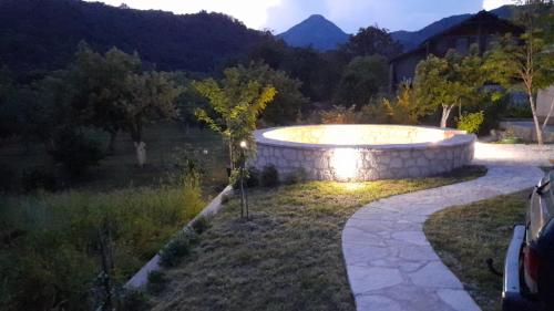 a swimming pool in a yard with a driveway at Aleksa in Cetinje