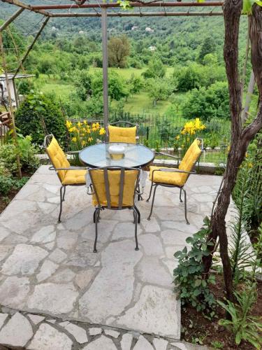 a table and chairs on a stone patio at Aleksa in Cetinje