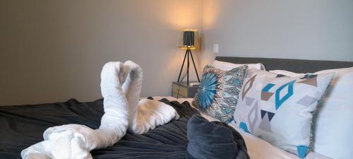 um cisne deitado em cima de uma cama em White Design Apartment em Aveiro