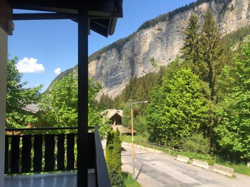 a view of a mountain from a porch at Hôtel la Kinkerne in Morzine