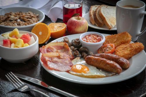 a plate of breakfast food on a table at The Crown London, WorldHotels Distinctive in London