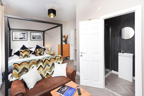 a bedroom with a large bed and a couch at Ocho Homes by Eight Continents in Belfast
