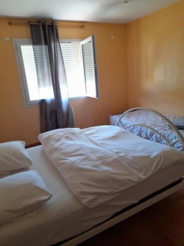 1 dormitorio con 1 cama blanca y ventana en Villa natasa en Saint-Laurent-de-la-Salanque