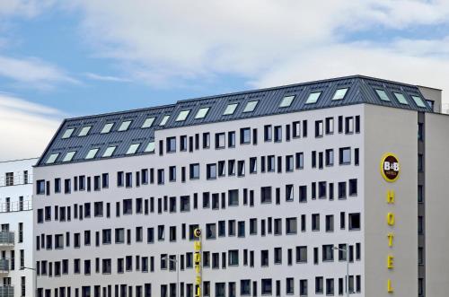 a white building with a black roof at B&B Hotel Wien-Hbf in Vienna