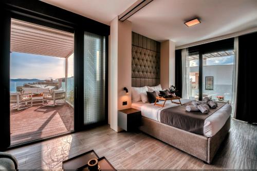 a bedroom with a large bed and a balcony at Dedaj Resort - Villa Almaro in Zadar
