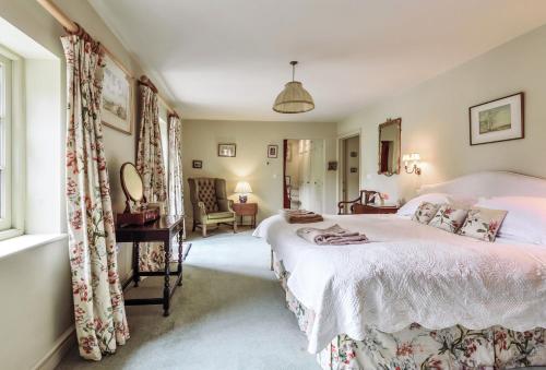 a bedroom with a bed and a living room at The Old Rectory Lodge in Dorchester