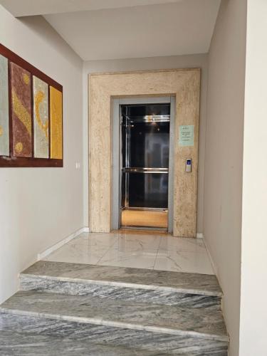 a hallway with a door and a window at SunBorn Hotel in Golem