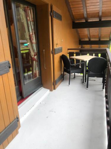an empty patio with tables and chairs in a restaurant at Hôtel la Kinkerne in Morzine