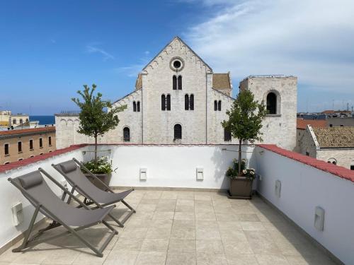 a pair of chairs on the roof of a building at Nonno Nicola Rooms in Bari