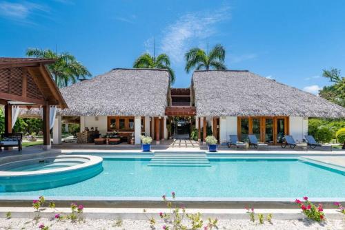 a villa with a swimming pool and a resort at YARARI 17 PRIVATE RETREAT W POOL JACUZZI MAiD in Punta Cana