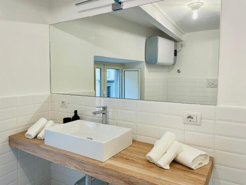 a bathroom with a white sink and a mirror at Garibaldi Accommodation in Viterbo