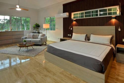 a bedroom with a large bed and a living room at Villa Careta Tortuga B55 in Punta Cana