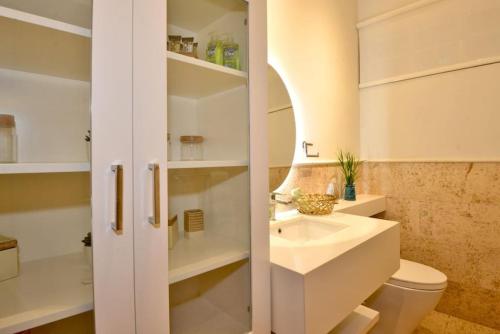 a bathroom with a toilet and a sink at Villa Careta Tortuga B55 in Punta Cana