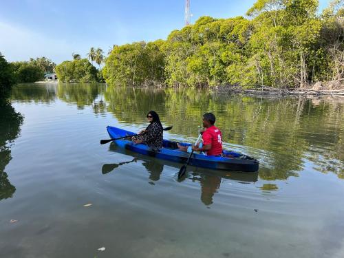a man and woman in a kayak on a lake at Wish Guesthouse in Huraa