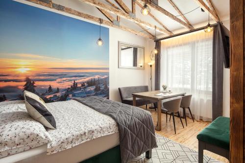 een slaapkamer met een bed en een eettafel bij Mumlava Resort Harrachov in Harrachov