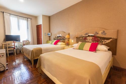 Кровать или кровати в номере Hotel Rosario La Paz