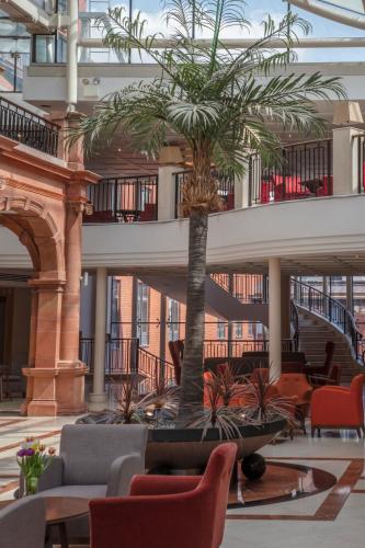 a palm tree in the middle of a lobby at The Crown London, WorldHotels Distinctive in London