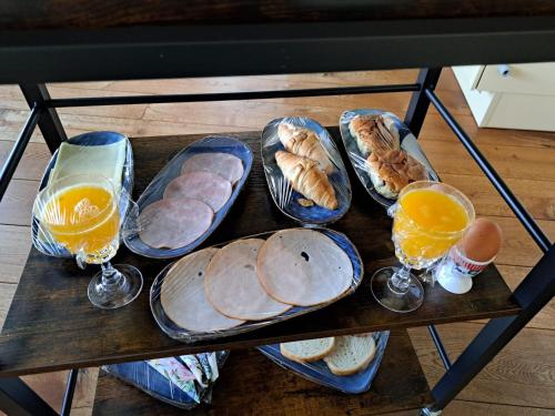 a tray of bread and eggs and glasses of orange juice at Levenslust Hulshorst in Hulshorst