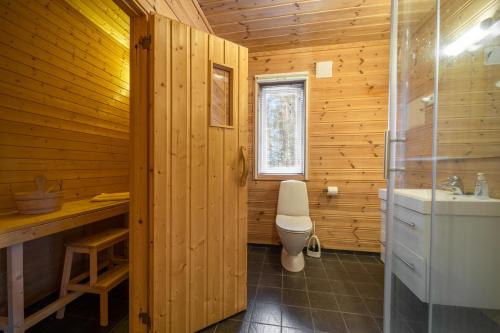 La salle de bains en bois est pourvue de toilettes et d'un lavabo. dans l'établissement Gezellige woning met hottub en sauna, à Vradal