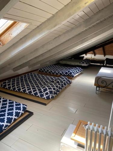 a attic room with three beds on the floor at Villa Gioia in Acqui Terme