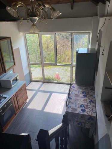 a kitchen with a table in a room with windows at Villa Gioia in Acqui Terme