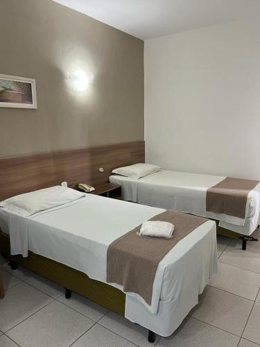 a hospital room with two beds in it at Larison Economy by Easy Hotéis in Porto Velho