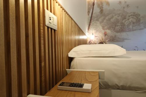 a room with a bed and a remote control on a table at SUNSEA - Enjoy Your Family in Capo Vaticano