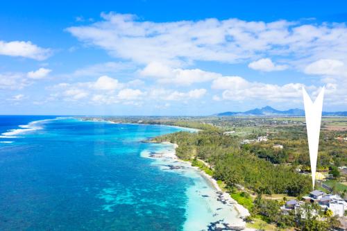 an aerial view of the beach and the bridge to the ocean at Beach Penthouse BELMARE in Belle Mare