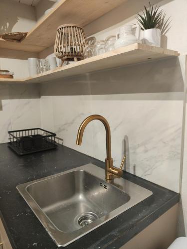 a kitchen sink with a black counter top at Casa Maria Flora in Ojén
