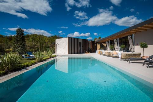 a swimming pool in the backyard of a house at Floria Glamping Garden in Labin