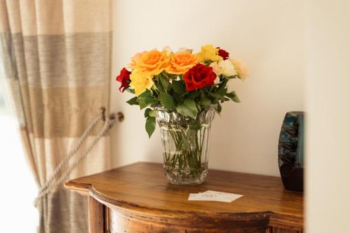 a vase of flowers sitting on top of a table at Aux Truffes de Combecave in Mauroux