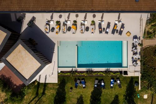 an overhead view of a swimming pool with a group of chairs at Floria Glamping Garden in Labin