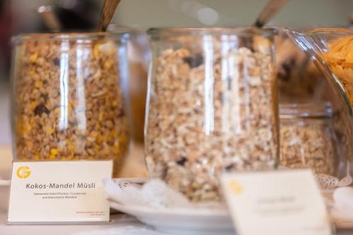 three jars of granola on a table with labels at Donauhof - Hotel garni in Weissenkirchen in der Wachau