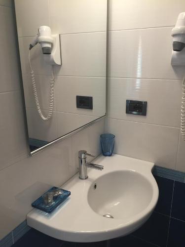 a bathroom with a white sink and a mirror at La Rosa Dei Venti in Monterosso al Mare