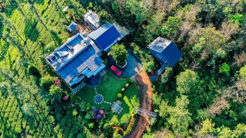 an overhead view of a large house in the forest at Villa Tesori - Holiday home overlooking a river & waterfalls in Meppādi
