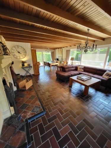 a living room with a couch and a table at villa 2be in Balen
