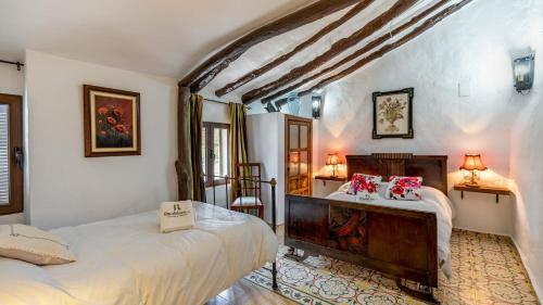 a bedroom with two beds and a table with two lamps at Cortijo Bustamante Baza by Ruralidays in Baza
