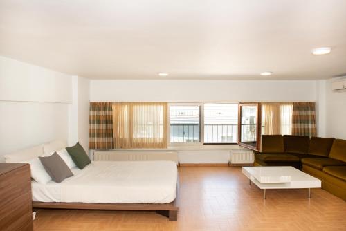 a living room with a couch and a table at City Chic Apartments in Limenas