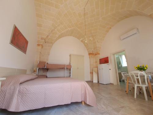 a bedroom with a bed in a stone wall at Casa Vacanza Fontana in Manduria