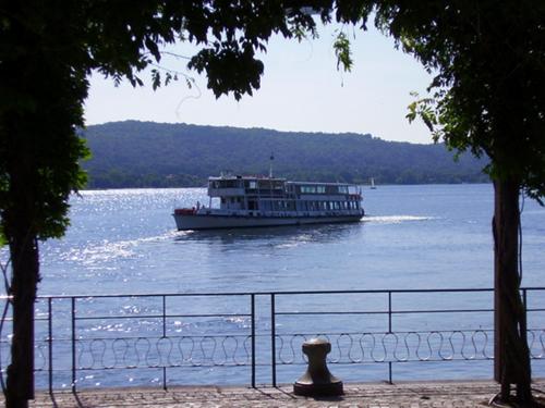 a large boat on the water in a lake at Lakeview Cannobio Camping & Resort in Cannobio