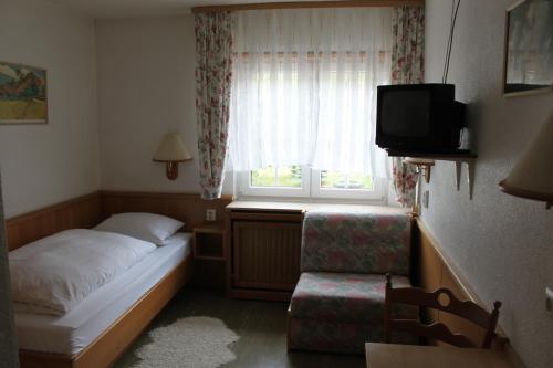 a small bedroom with a bed and a window at Gasthof Jäger in Heppenheim an der Bergstrasse