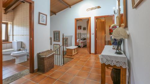 a bathroom with a toilet and a sink at Casa rural la Galvana Aracena by Ruralidays in Aracena