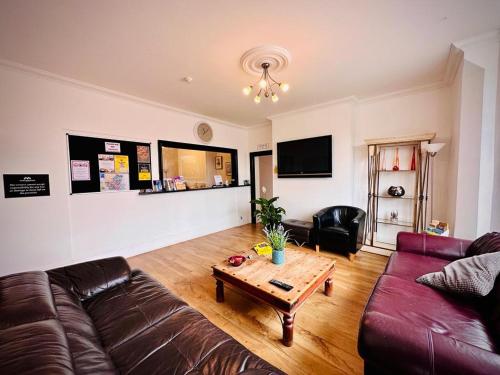 a living room with a couch and a coffee table at Marlborough Hotel in Norwich