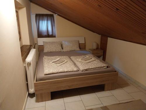 a bedroom with a bed with two towels on it at Apartmani Vukan in Novi Sad