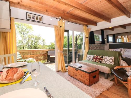 a living room with a couch and a table at Dart View Hideout in Totnes