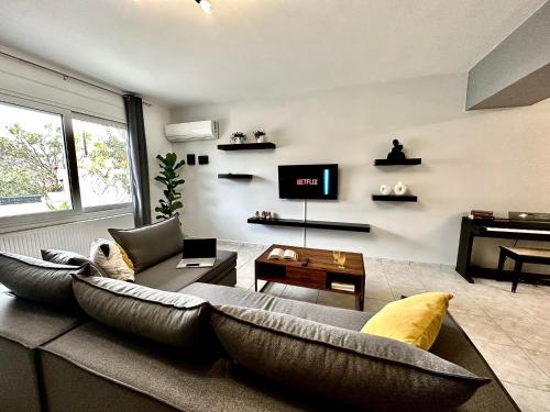 a living room with a couch and a tv at Mylos Ηome in Ierápetra