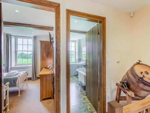 a room with a mirror and a bathroom with a tub at Warth House - Uk44209 in Ingleton