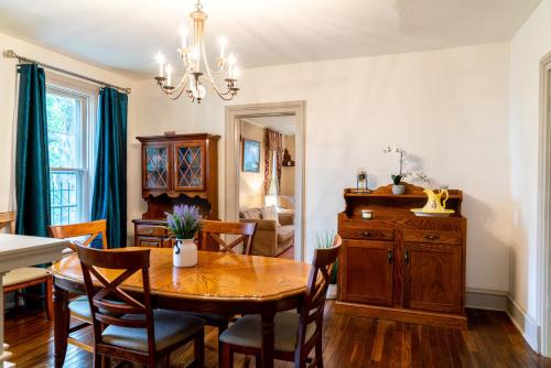 a dining room with a wooden table and chairs at CHARMING EXECUTIVE VICTORIAN MANSION w/ FREE PARKING - near Bucknell in Milton