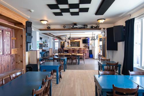 a dining room with blue tables and chairs at La Secousse in La Malbaie